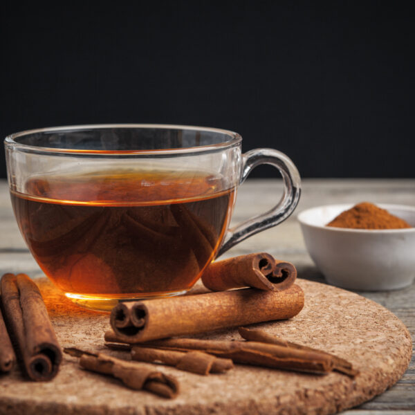 aromatic hot cinnamon tea on wooden table. creative photo.