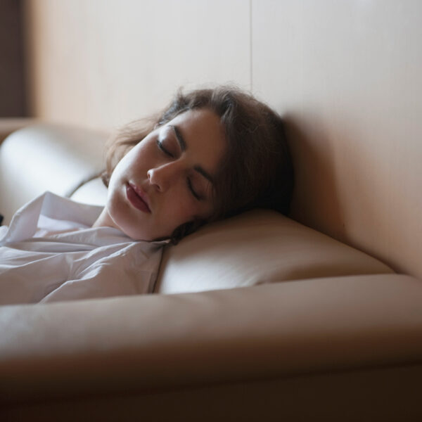 businesswoman sleeping on couch